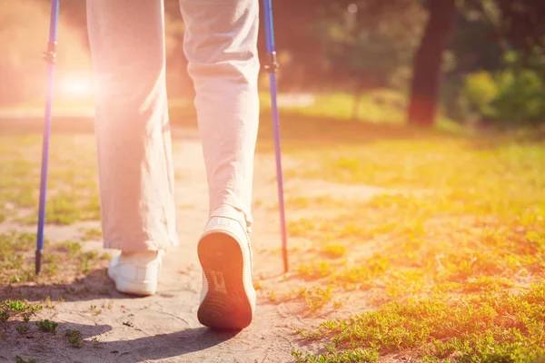 Elderly woman walking with crutches — Stock Photo, Image