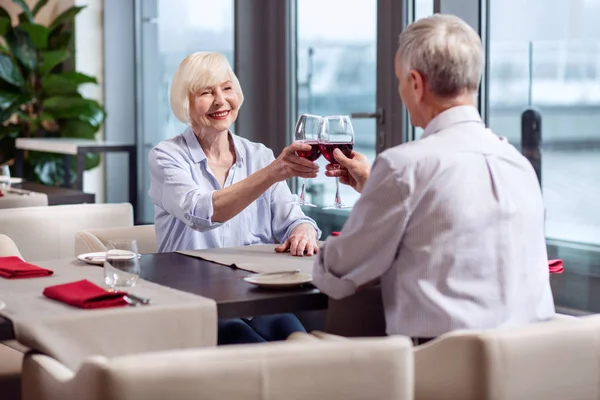 Pěkný starší pár cinkání sklenic vína — Stock fotografie