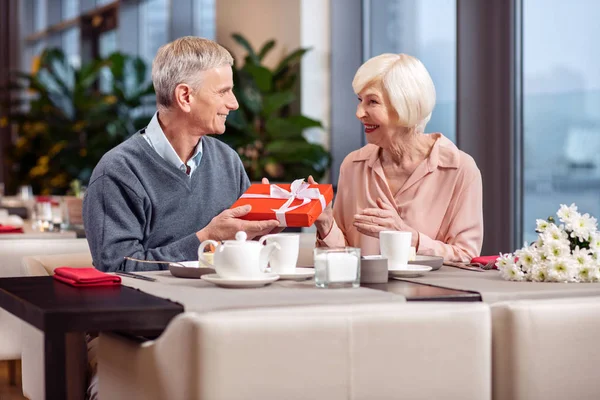 Joyful mature couple celebrating anniversary