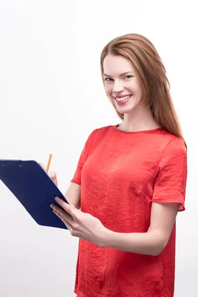 Ingwerhaarige Frau füllt Formular auf Zettelhalter aus — Stockfoto