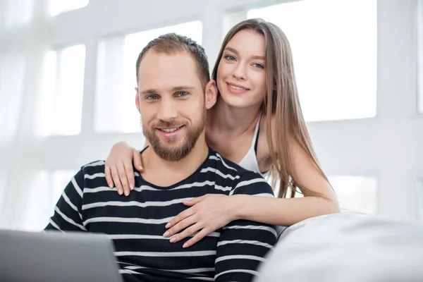 Merry young woman embracing her man — Stock Photo, Image