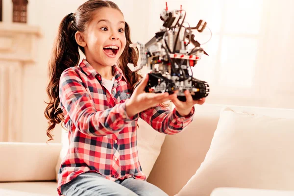Excited preteen child getting emotional over robot toy — Stock Photo, Image