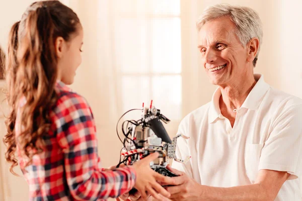 Membros da família extremamente felizes conversando sobre novo brinquedo robô — Fotografia de Stock