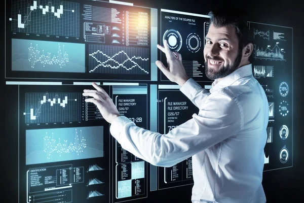 Optimistic man working at the new program and smiling — Stock Photo, Image