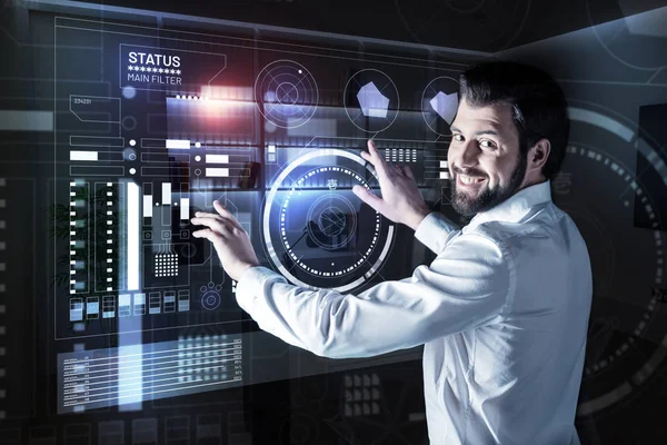 Positive specialist feeling confident while working with futuristic technologies — Stock Photo, Image