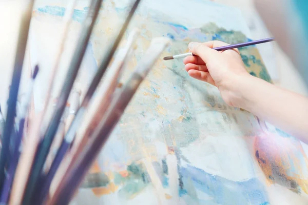 Scaled up look on young painter working on abstract picture — Stock Photo, Image