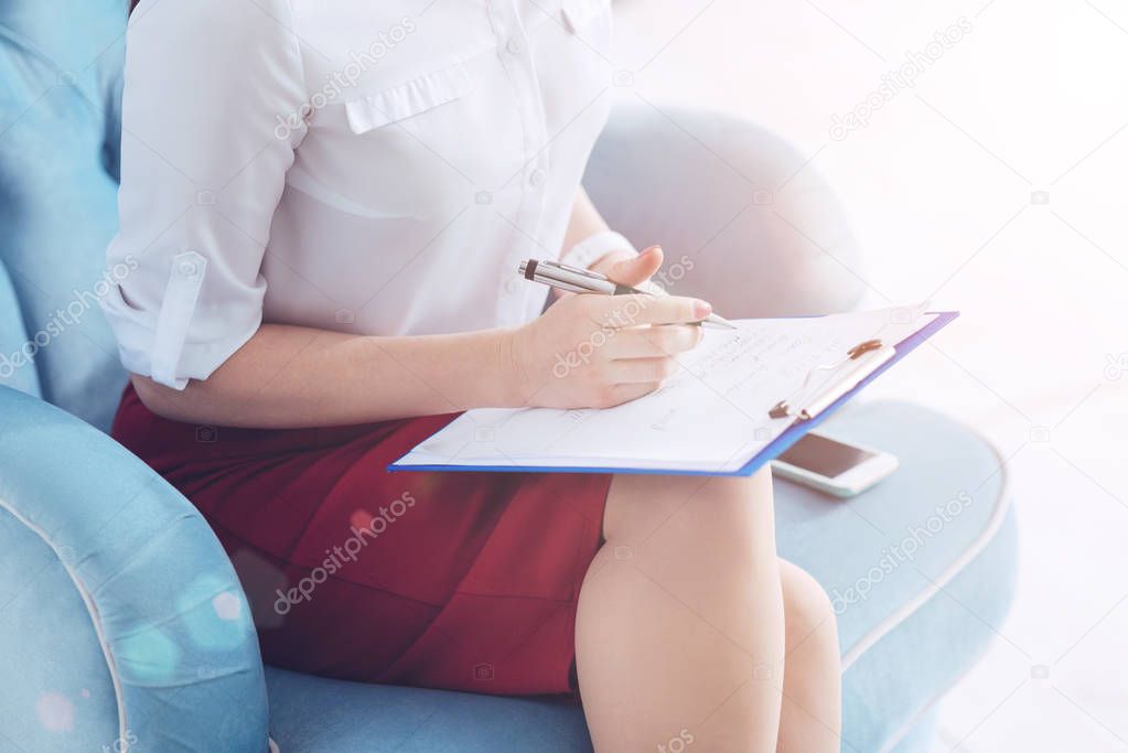 Scaled up look woman making notes at office