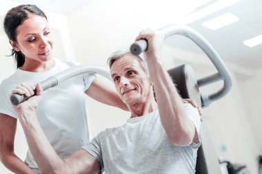 Neşeli ihtiyar kadın onun eğitmeni ile egzersiz