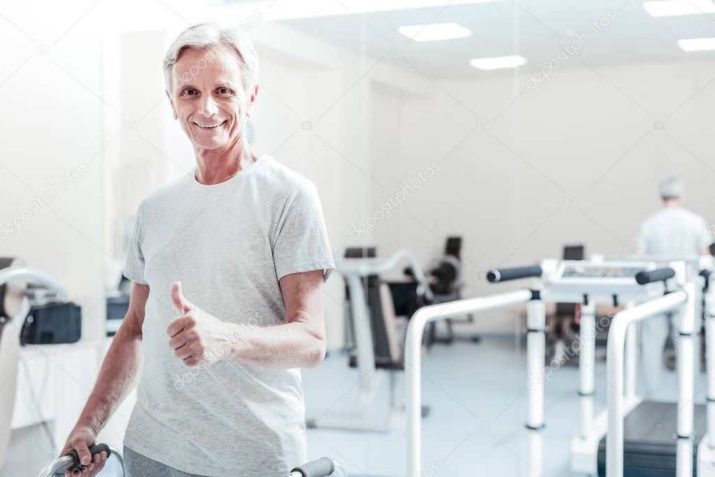 Content baby-boomer standing in the gym