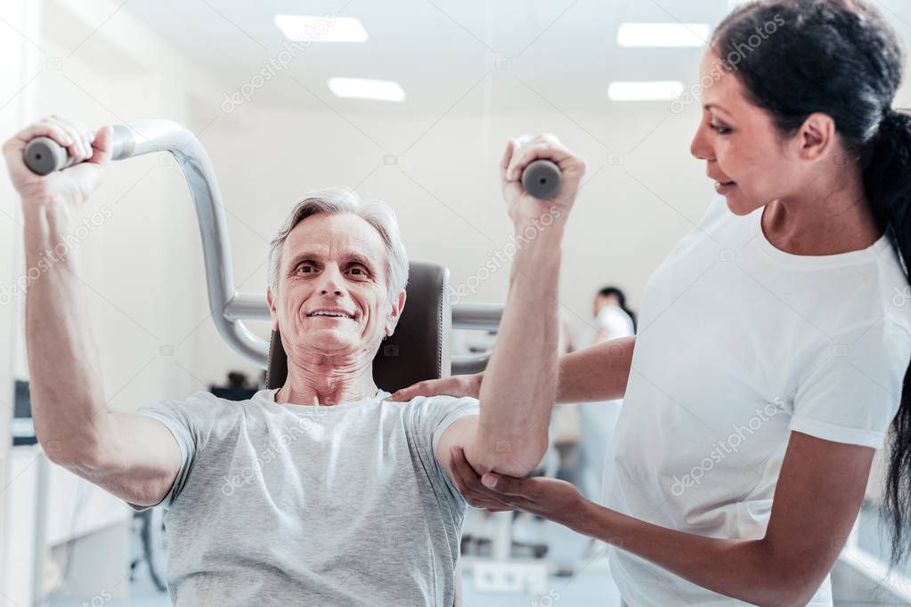 Energetic old man exercising in the gym