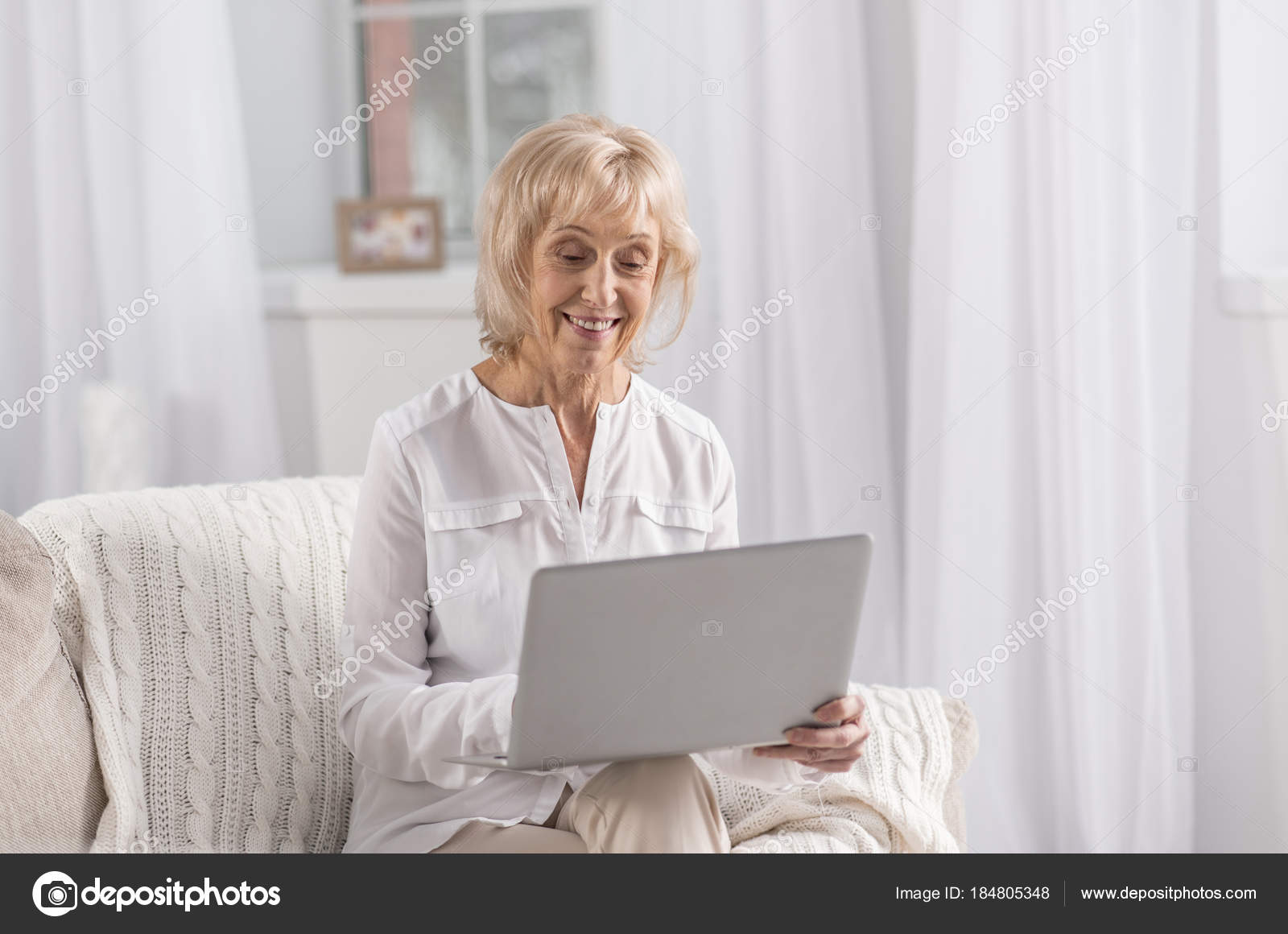 cheerful mature woman searching web stock photo yacobchuk1