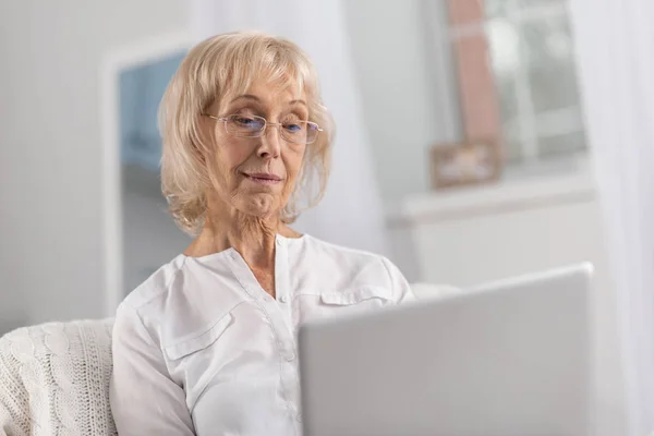 Elegant mature woman watching movie — Stock Photo, Image