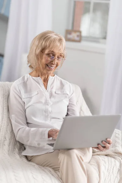 Glad mature woman choosing movie — Stock Photo, Image