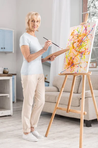 Pensive mature woman drawing abstraction — Stock Photo, Image