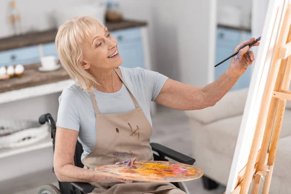 Mature disabled woman developing her talent — Stock Photo, Image