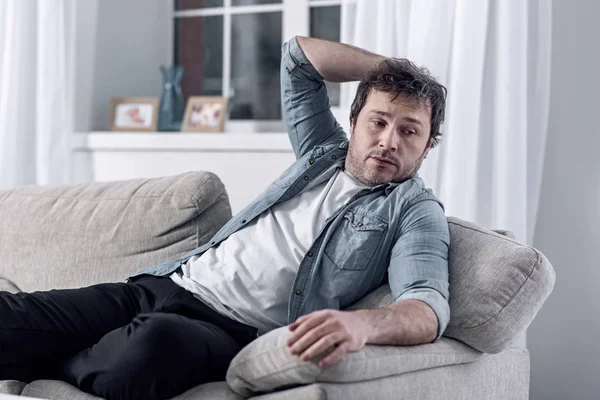 Lazy man resting on the sofa instead of looking for a job — Stock Photo, Image