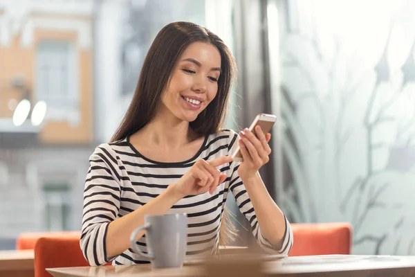 Positive happy woman holding her gadget — Stock Photo, Image