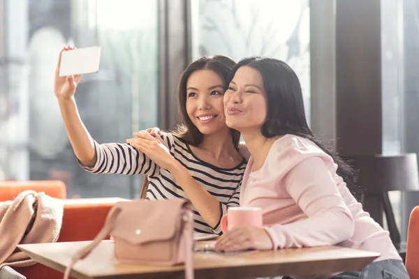 Happy delighted women taking selfies — Stock Photo, Image