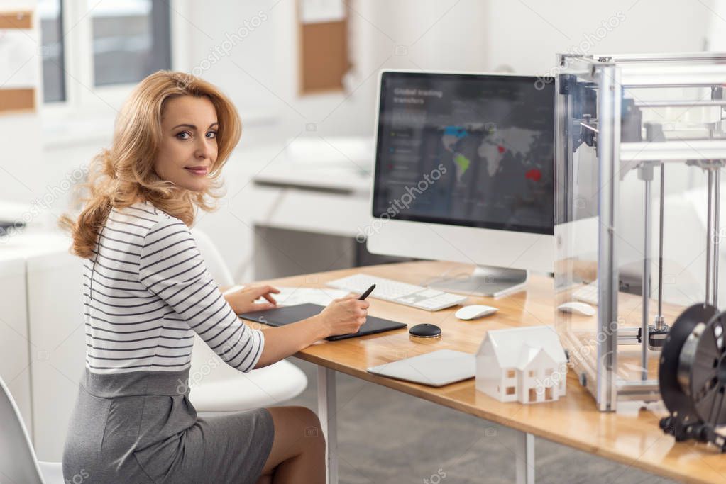 Beautiful young woman posing while working on presentation design