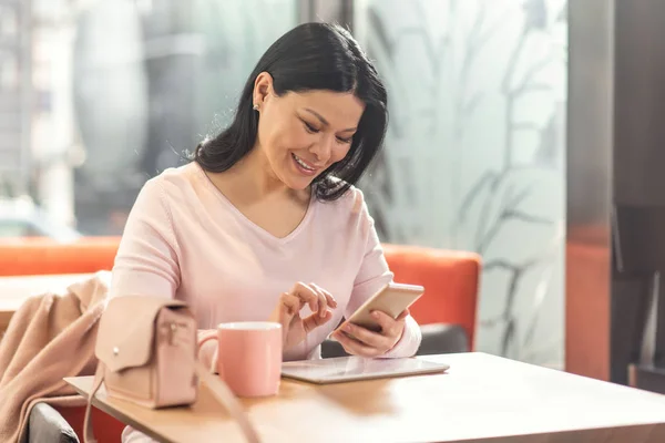 Cheerful positive woman using social media — Stock Photo, Image