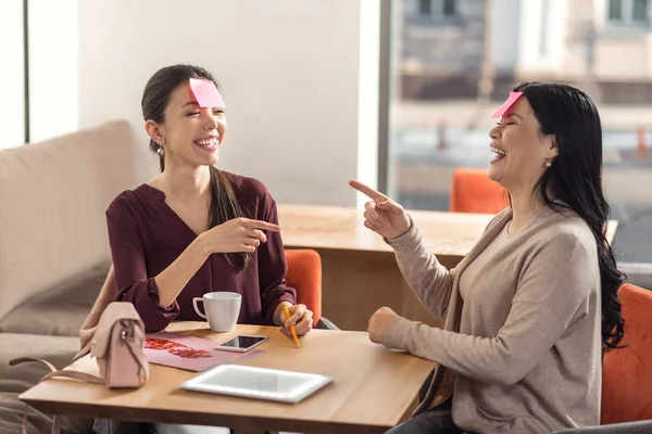 Happy delighted women playing a game