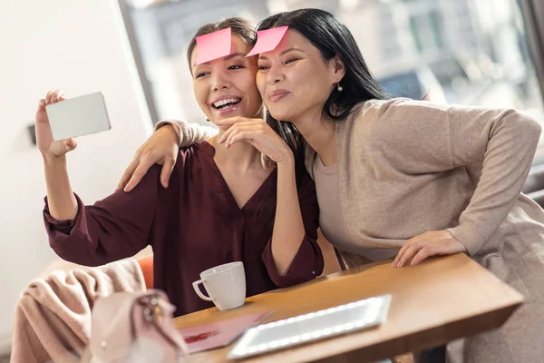 Happy delighted women taking a photo — Stock Photo, Image