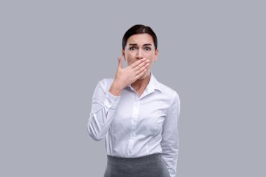 Terrified woman closing her mouth his her hands clipart