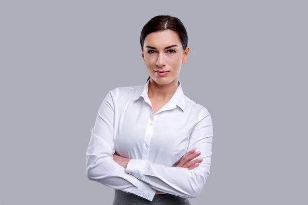 Happy woman standing with her arms crossed — Stock Photo, Image