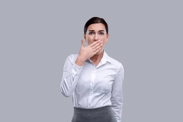 Terrified woman closing her mouth his her hands — Stock Photo, Image