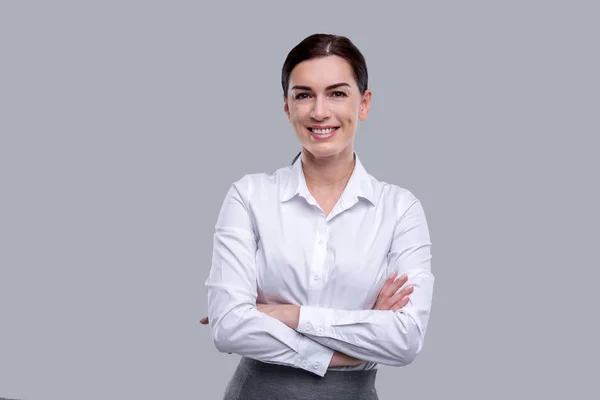 Smiling woman standing with her arms crossed — Stock Photo, Image