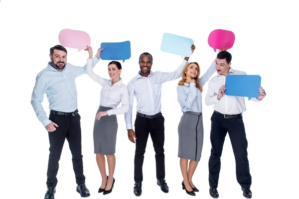 Cheerful co-workers holding tables over each others heads — Stock Photo, Image