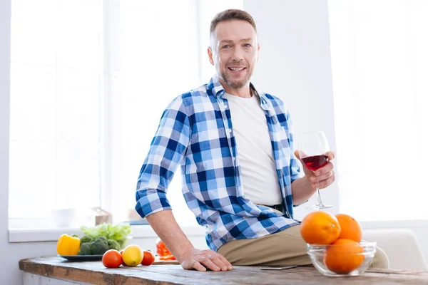 Enthusiastic bearded man elevating glass of wine — Stock Photo, Image