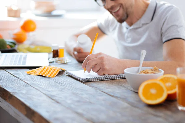 Male hands classifying biohacking supplements — Stock Photo, Image