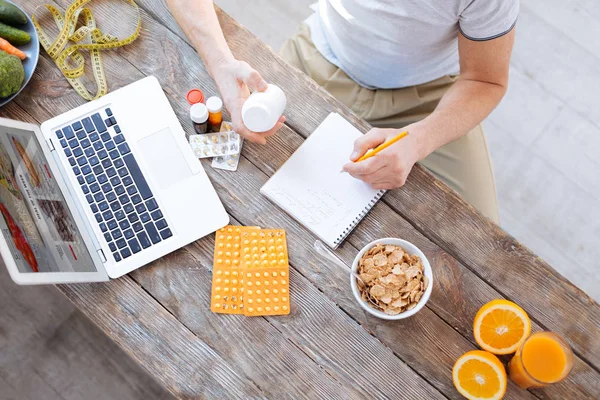 Young male hands writing down tips — Stock Photo, Image