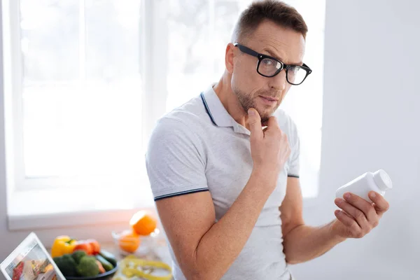 Pensive thoughtful man studying biohacking drug — Stock Photo, Image