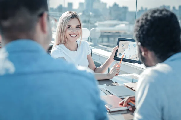 Beaming freelancer showing her project ideas to colleagues — Stock Photo, Image