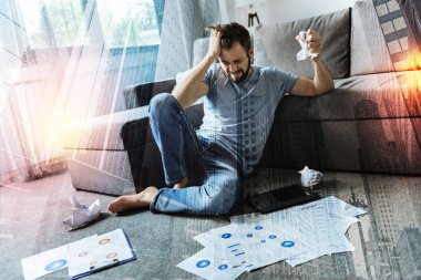 Desperate man closing his eyes and scrunching documents clipart