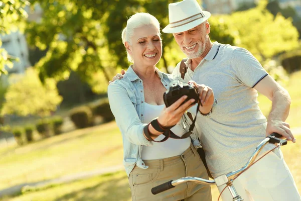 Cheerful elderly woman standing together with her husband