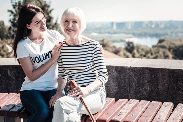 Joyful happy woman sitting on the bench