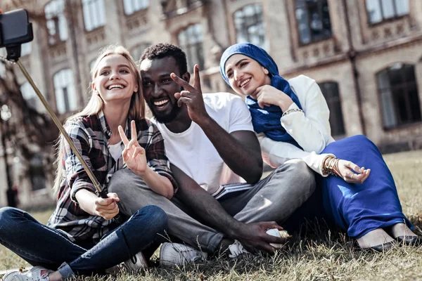 Cheerful emotional student showing V sign — Stock Photo, Image