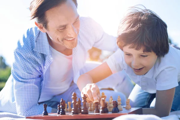 Orgulhoso pai assistindo filho jogando xadrez — Fotografia de Stock