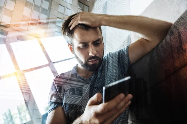 Worried man discovering unpleasant news when reading messages — Stock Photo, Image