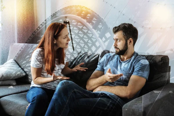 Emotional woman feeling terrible while talking with her boyfriend — Stock Photo, Image