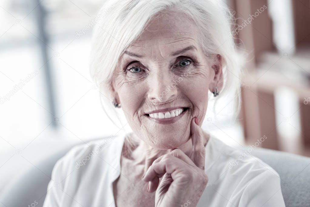 Delighted female person posing on camera