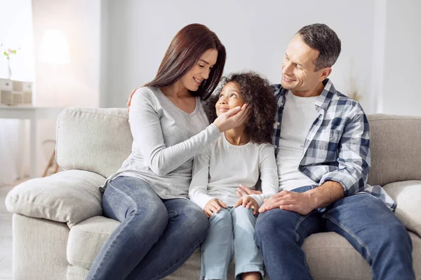 Delighted family sitting on the sofa