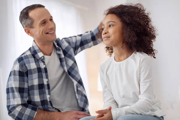 Smiling daddy caressing his daughter — Stock Photo, Image