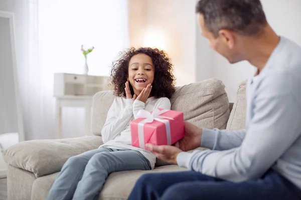 Ägnas åt pappa håller en present till sin dotter — Stockfoto