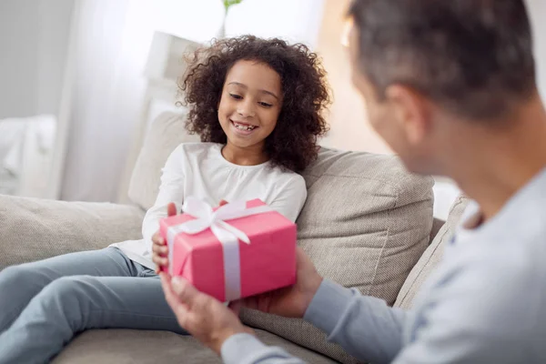 Loving father holding a gift for his daughter — Stock Photo, Image