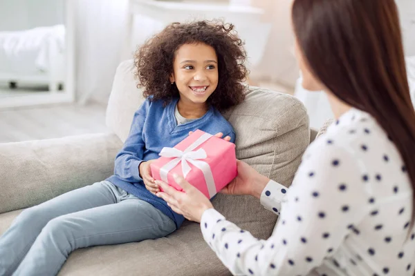 Loving mother giving her daughter a gift — Stock Photo, Image