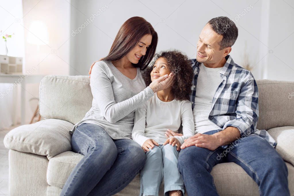 Delighted family sitting on the sofa